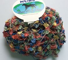 a ball of multicolored yarn with a white tag on the top that says nubs