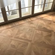 an empty room with wooden floors and glass doors