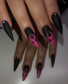 Matte black is one of those nail polish colors that is quite extraordinary to apply. If you want to try something new on your matte black nails, why not opt for glittered pink flames? Let's give it a shot. Extraordinary Nail Designs, Black And Neon Pink Nails, Hot Pink And Black Nails Acrylics, Summer Goth Nails, Pink Flame Nails, Dark Blue Nail Polish, Pink Flames, Hottest Nail Trends