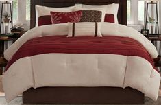 a bed with red and white comforters in a bedroom