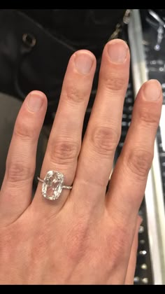 a woman's hand with a diamond ring on it