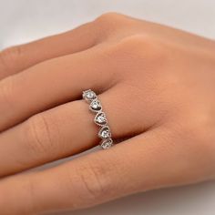 a woman's hand with a diamond ring on it