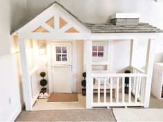 there is a doll house with a porch and stairs