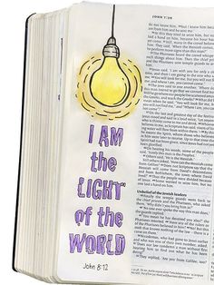 an open bible with the words i am the light of the world