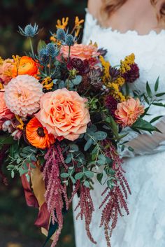 a woman holding a bouquet of flowers in her hands