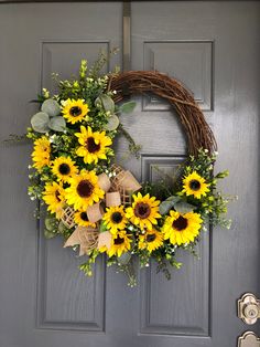 a wreath with sunflowers on the front door