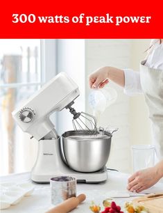 a woman pouring batter into a bowl on top of a table next to other ingredients