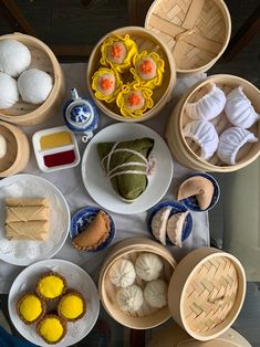 a table topped with bowls filled with different types of foods and desserts on top of it