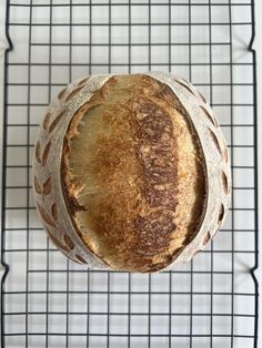 a loaf of bread sitting on top of a cooling rack