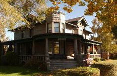 an old victorian style house in the fall