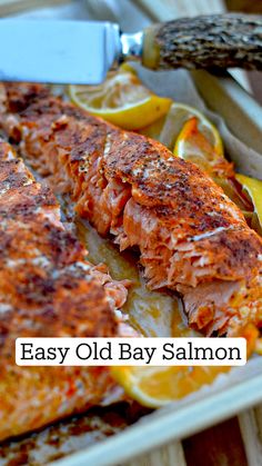 an easy old bay salmon recipe with lemons and herbs on the side, ready to be eaten