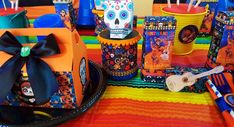 colorful mexican themed party supplies and decorations for a day of the dead birthday party on a table