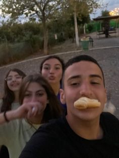 a group of young people standing next to each other with food in front of them