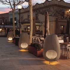 outdoor seating area with tables and umbrellas at dusk