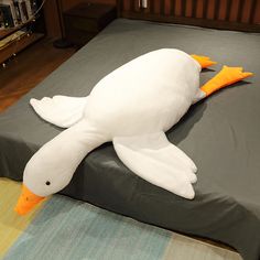 a stuffed duck laying on top of a bed