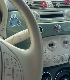 the interior of a car with stickers on it's dash board and steering wheel