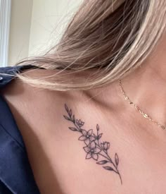 a woman with a flower tattoo on her chest