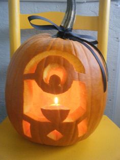 a carved pumpkin sitting on top of a yellow chair