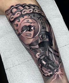 a man's arm with a mechanical tattoo on it