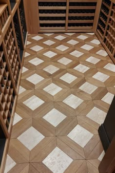 a wine cellar with wooden shelves and tiled floors