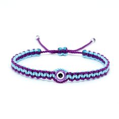 Hand-Made Blue And Purple String Bracelet With An Evil Eye For Wrist Sizes 6 To 9 In. With An Easy To Use Zip Like Function To Fit Your Wrist, You'll Have It On As Soon As You Get It. Made From High-Quality Blue And Purple String, It Will Be Sure To Last. Wearing An Evil Eye As An Amulet Is Believed To Provide Protection Against Evil Forces. The Evil Eye Meaning Has Symbolism In Almost Every Country In The World And In Every Religion. Each Bracelet Is Carefully Handcrafted And Given Proper Time Evil Eye Meaning, Protection Against Evil, Eye Meaning, Evil Eye Protection, Braided Bracelet, String Bracelet, Eye Protection, Womens Jewelry Bracelets, Evil Eye