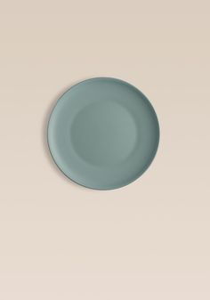 an empty blue plate on a beige background