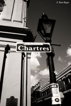 a street sign on a pole in front of a building