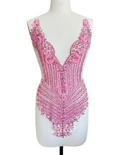 a white mannequin with pink beading on it's chest and back