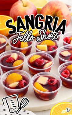 sangria fall shots with oranges, raspberries and apples in plastic cups