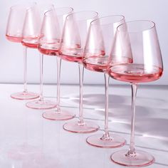 five wine glasses lined up in a row