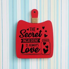 a red magnet with the words, the secret ingredient is always love on it's side