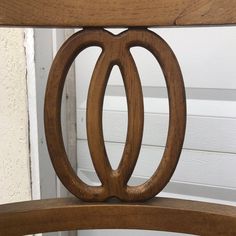 a wooden chair with an oval design on the back