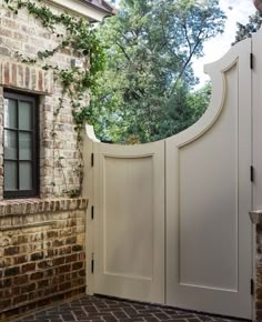 an open white door leading to a brick building