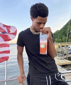 a man standing on a boat holding an empty water bottle