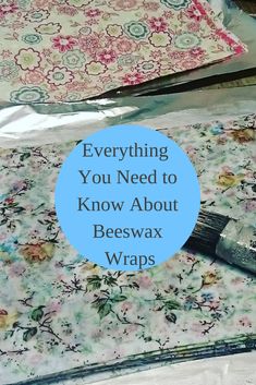 a painting brush sitting on top of a piece of fabric with the words everything you need to know about beeswax wraps