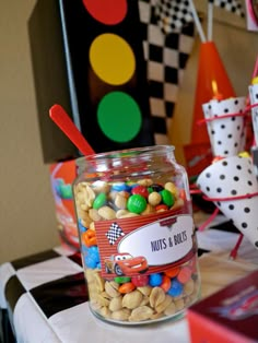 a jar filled with lots of candy sitting on top of a table