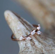 a rose gold ring with three diamonds on it