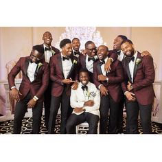 a group of men in tuxedos posing for a photo