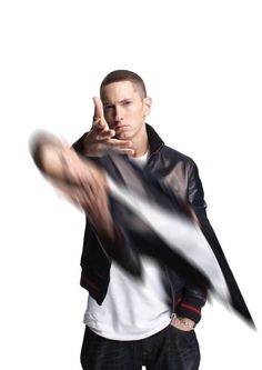 a man in a leather jacket pointing at something with his finger while standing against a white background