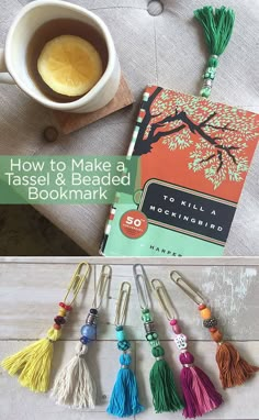 the book how to make a tassel and beaded bookmark is next to a cup of coffee