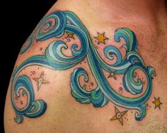 a man's chest with blue swirls and stars on the top of it