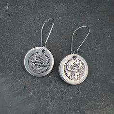 These are small aluminum circles, measuring 5/8", hung on surgical stainless steel ear wires, that measure approximately 3/4". Please see photo as to how far down they will dangle. I hand stamp the small design on them.  These wires are stainless steel, won't tarnish the hand-stamped charms will not tarnish either. This is a custom piece that is made when it is ordered, and the photo is just a representation of what you will receive. The hand stamped lettering or images might be spaced slightly Stamped Earrings, Small Design, Hand Written, Small Designs, Alex And Ani Charm Bracelet, Ear Wires, Hand Stamped, Jewelry Earrings Dangle, Etsy Earrings