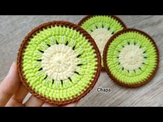 two crocheted kiwis sitting on top of a wooden table