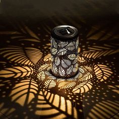 a can sitting on top of a table next to a shadow