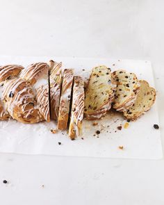 a bunch of doughnuts sitting on top of a piece of white parchment paper