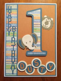 a happy 1st birthday card with an animal on the number one, and a teddy bear