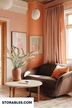 a living room with an orange wall and brown chair, coffee table and vase on the floor