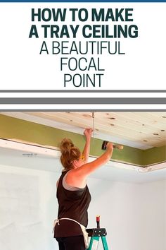 a woman is painting the ceiling in her home