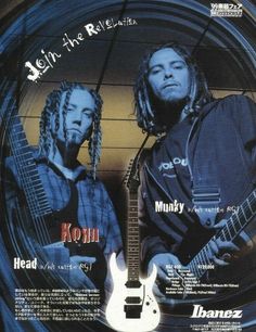 two men with dreadlocks are holding guitars and looking at the camera while standing next to each other