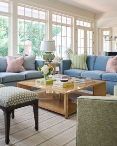 a living room filled with blue couches and pillows on top of it's sides